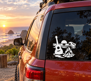 Vinyl decal graphic of a guitar with flames and campfire design on a window