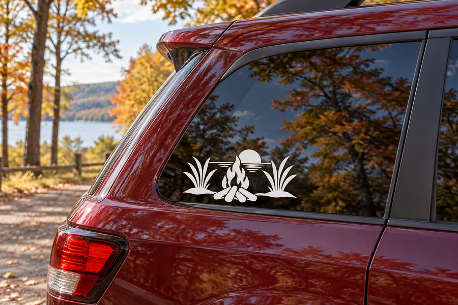 Vinyl car window decal with black silhouette beach grass and campfire scene
