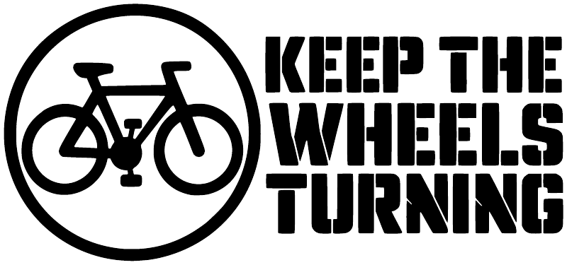 Black-and-white "KEEP THE WHEELS TURNING" vinyl bicycle decal with circular logo