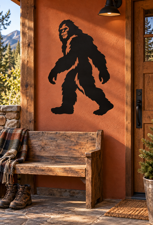 Bigfoot vinyl decal silhouette on an orange outdoor door