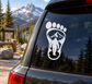 Bigfoot footprint vinyl decal with white paw, Bigfoot silhouette, and mountain trees