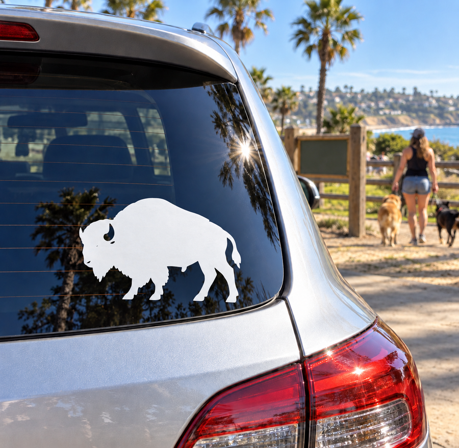 Vinyl decal of standing bison silhouette with curved horns, applied on car window