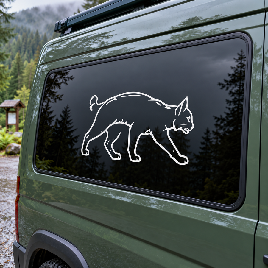 Bobcat outline vinyl decal with tufted ears, white design on dark window