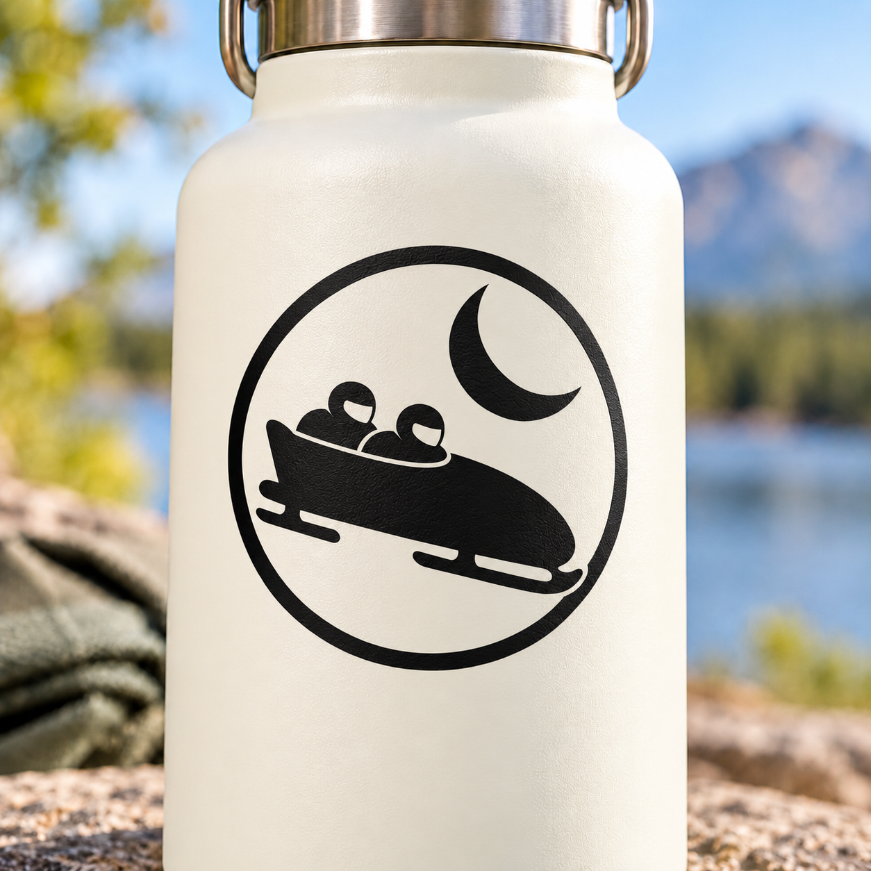 Circular vinyl decal with black bobsled and crescent moon logo
