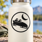 Circular vinyl decal with black bobsled and crescent moon logo