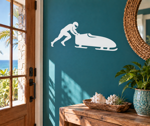 White bobsled push silhouette vinyl decal, runner figure pushing a bobsled.