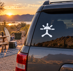 White sunburst and crossbones vinyl car decal on rear window