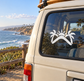 Vinyl palm sunset decal on car window glass, white boomerang-style silhouette with sun