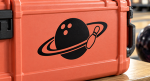 Vinyl decal featuring a black planet with orange dot craters and ring with small rocket icon