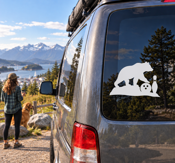 White vinyl decal of a bear with bowling ball and pin on a vehicle window