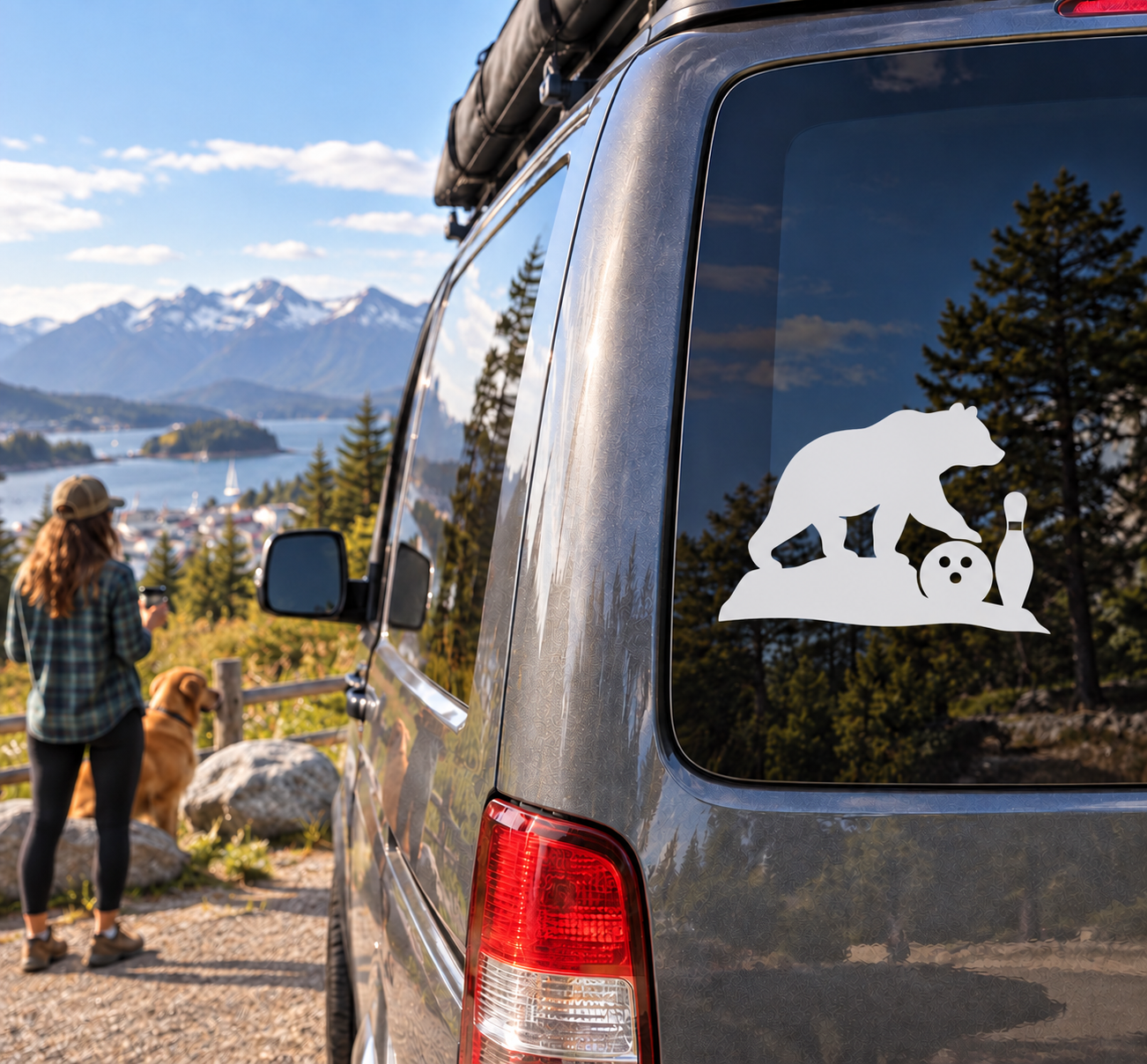 White vinyl decal of a bear with bowling ball and pin on a vehicle window