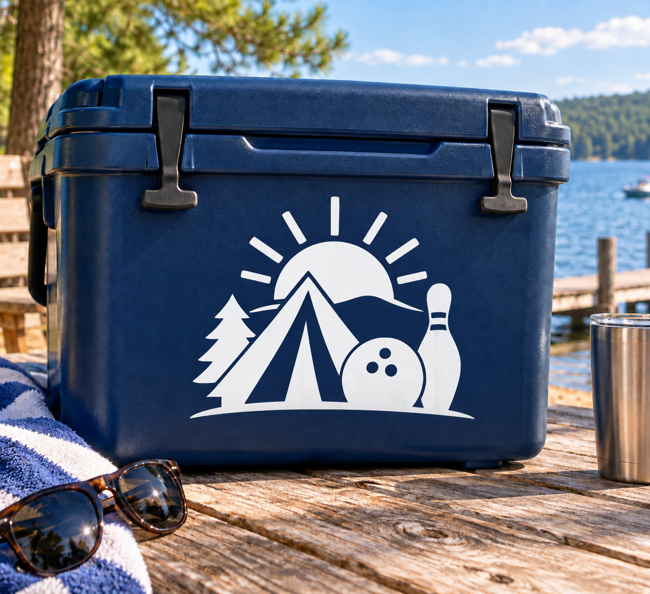White vinyl decal on blue cooler: mountain, pine trees, bowling pin, and sunburst