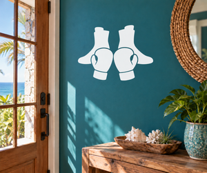 Boxing-themed vinyl decal of boxing boots and gloves, white on a wall