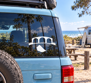 Black and white gate emblem vinyl decal on vehicle window