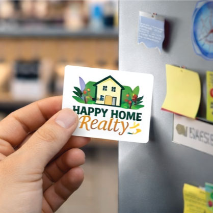 Business card magnet with house logo and "Happy Home" text, held in hand.