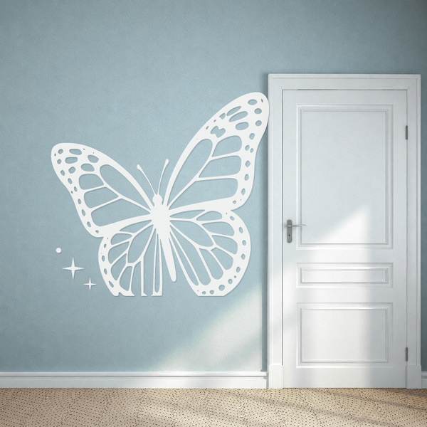 Mirrored butterfly wall decal with dotted wing borders and spark trail accents