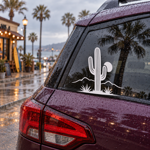 Vinyl decal of white cactus on dark car window with desert ridge and desert plants
