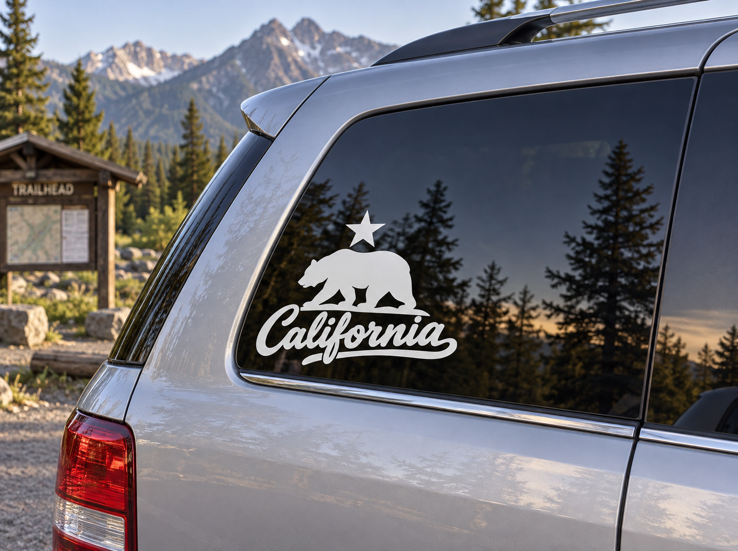 Vinyl decal of a black bear, star, and California script on a car window