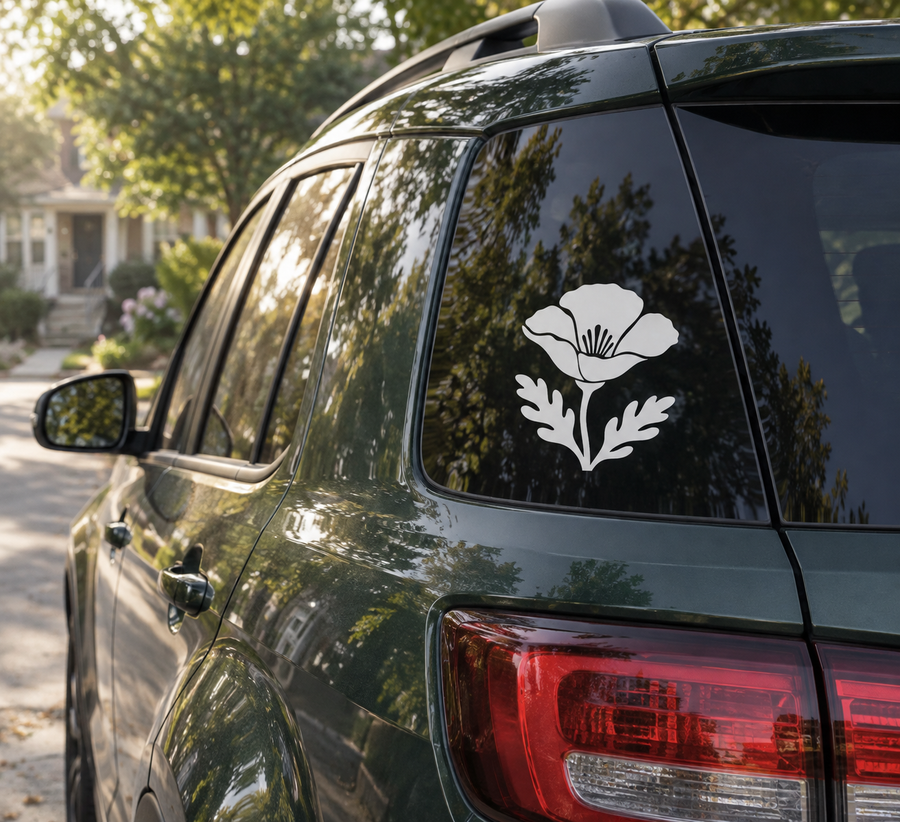 California poppy vinyl decal on dark car window, white flower and leaves