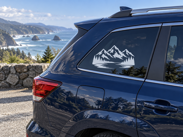 Vinyl decal of mountain peaks, pine trees, and snowy landscape on car window