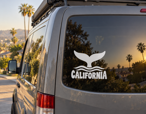 California whale tail vinyl decal with waves and the word “California” on a van window.