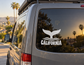 California whale tail vinyl decal with waves and the word “California” on a van window.