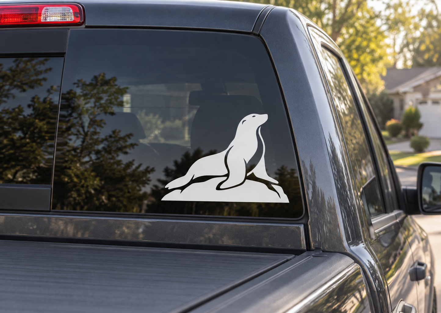 White sea lion on rock vinyl decal on car window