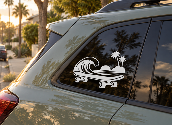Skateboard vinyl decal with wave, palm trees, and sunset graphic on a car window