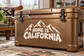 White vinyl decal with mountain graphic and 'Home is California' lettering