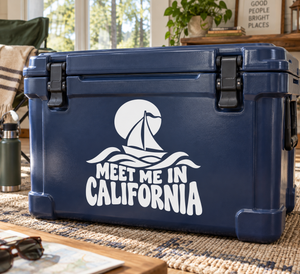 White vinyl decal with sailboat icon and 'MEET ME IN CALIFORNIA' lettering on cooler