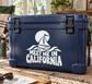 White vinyl decal with sailboat icon and 'MEET ME IN CALIFORNIA' lettering on cooler