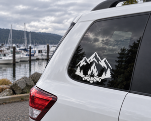 Mountain and pine tree vinyl decal with central flames and fire ring on rear window