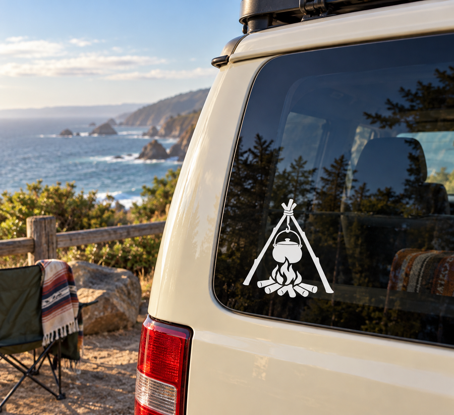 Black campfire kettle vinyl decal on car window, tripod and pot over flames