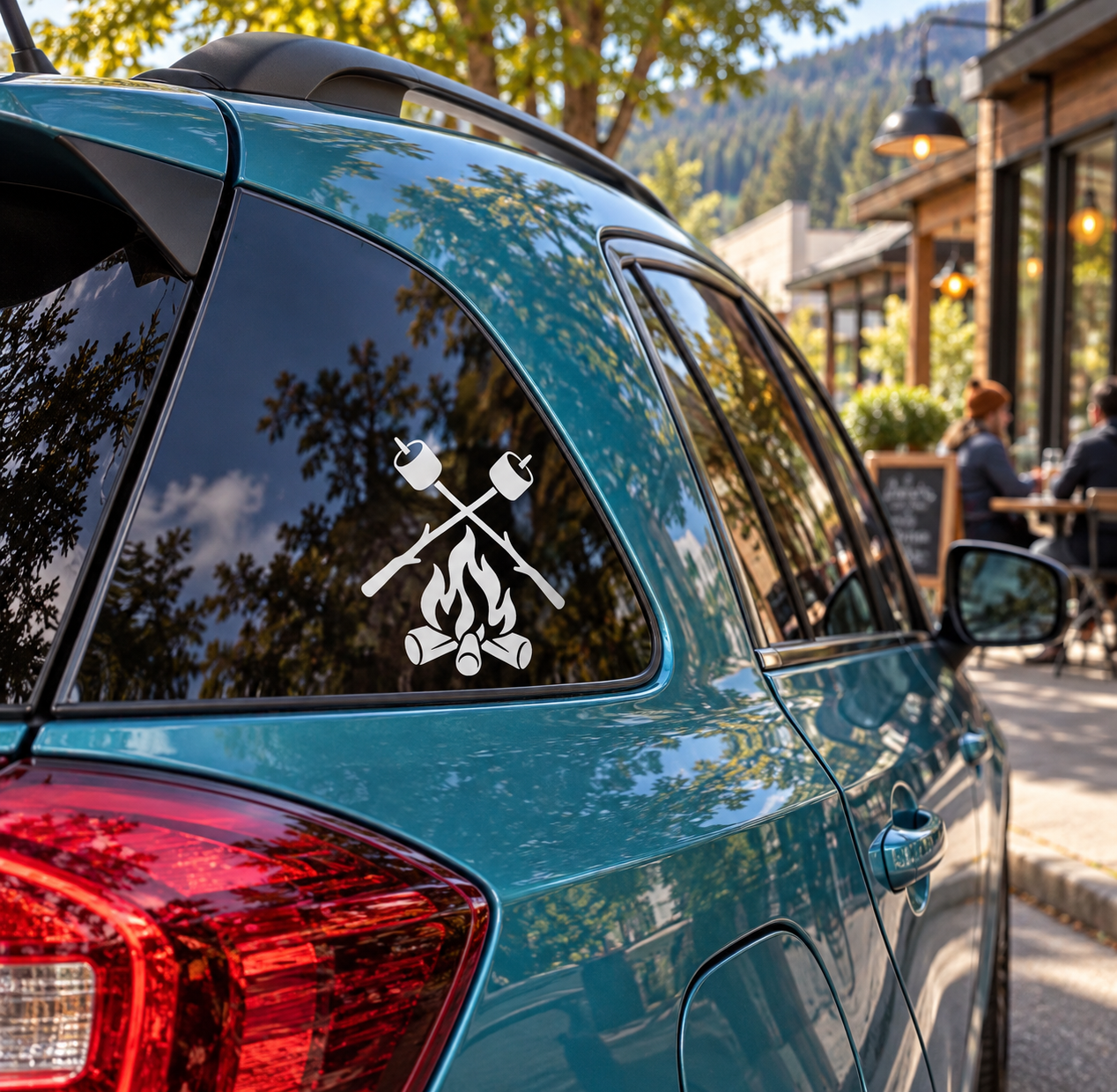 Black campfire and crossed-axes vinyl decal on car rear window