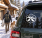 Alpine tent crest vinyl decal on car window, white hex emblem with mountains and tent