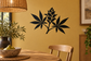Black botanical vinyl decal with leaf and flower cluster on wall