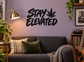 Stay Elevated vinyl decal with cannabis leaf icon, black wall lettering