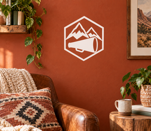 White vinyl decal badge with mountain peaks and megaphone icon.