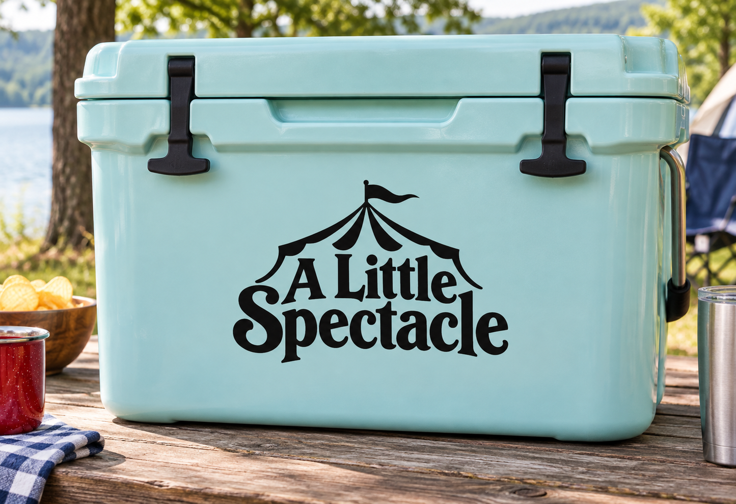 Black vinyl decal with circus tent and text "A Little Spectacle" on a cooler