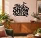 Black vinyl wall decal with circus tent and “The Show Goes On” lettering