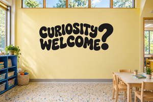 Black vinyl wall decal reading “Curiosity Welcome?”