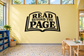 Black and white "Read Beyond the Page" vinyl wall decal with open-book icon