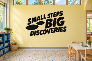 Vinyl wall decal reading “Small Steps Big Discoveries” with footprint graphics