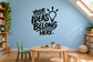 Vinyl wall decal with black text “YOUR IDEAS BELONG HERE” and lightbulb icon