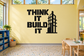 Black vinyl wall decal: “Think It Build It” with building graphic