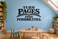 Vinyl wall decal with “Turn Pages Find Possibilities” quote in black lettering