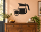Coffee carafe and cup vinyl wall decal with black silhouette, sized for easy placement