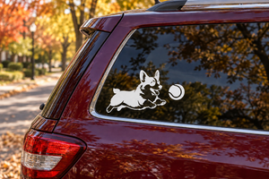 Vinyl decal of a corgi fetching a ball on a car rear window