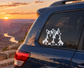Vinyl decal of two corgis sitting on a car window
