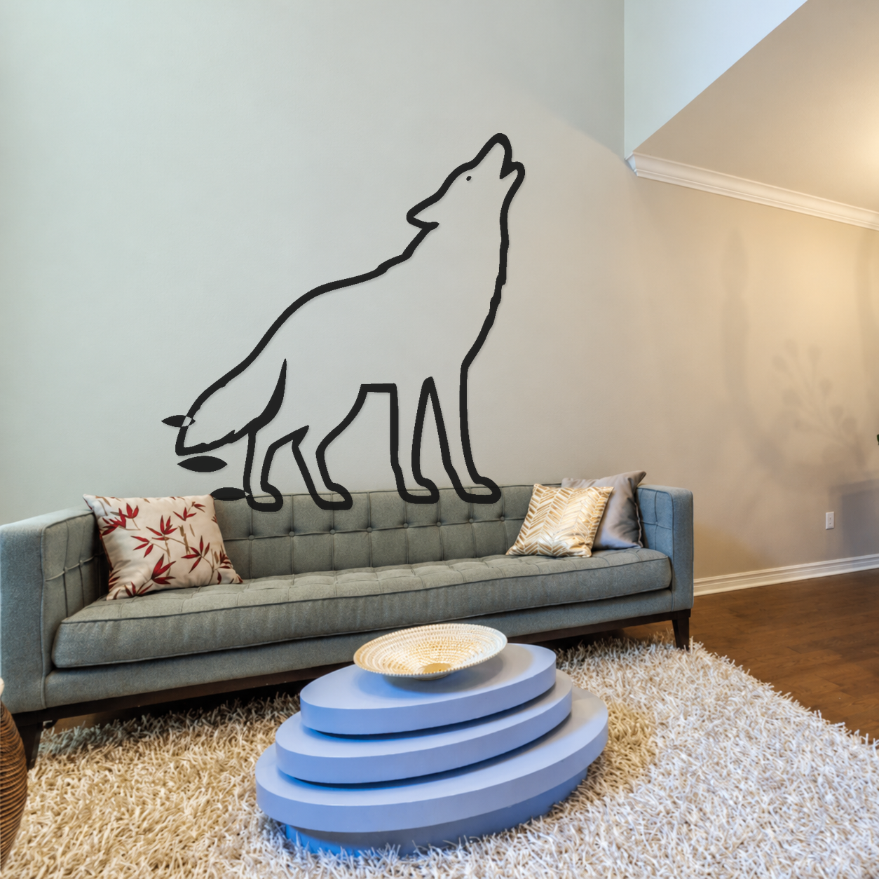 Black mirrored coyote outline wall decal with three botanical leaf accents.
